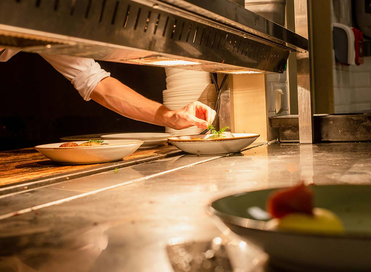 A person preparing dishes in a restaurant