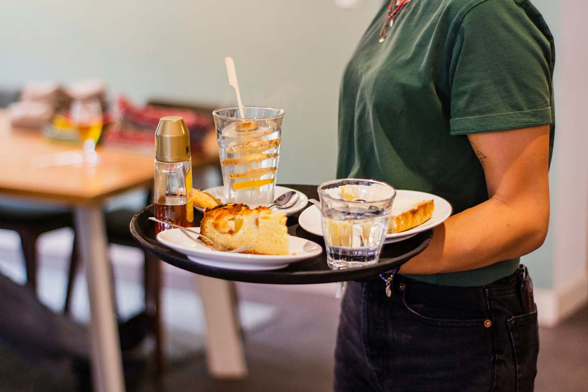 A server delivering food in a restaurant