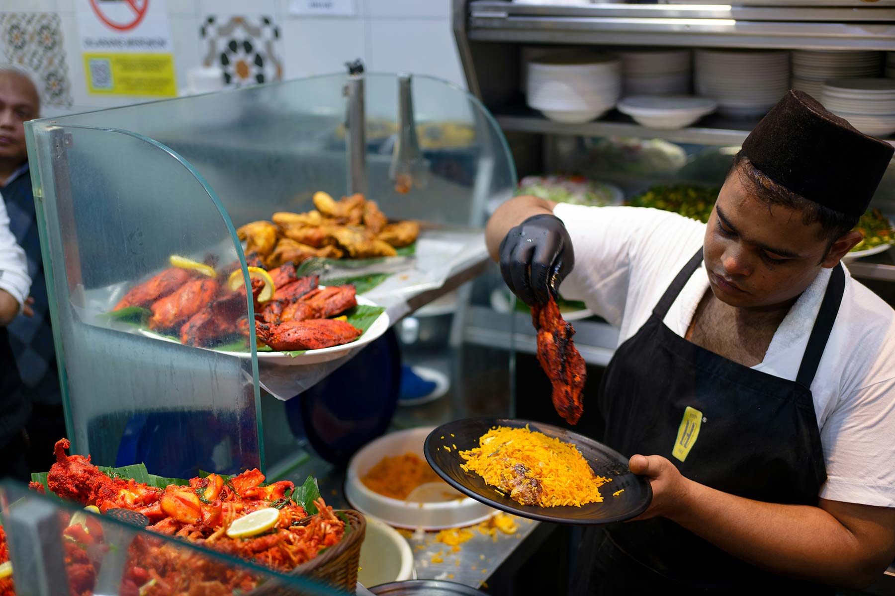 A cook serving food at a restaurant 